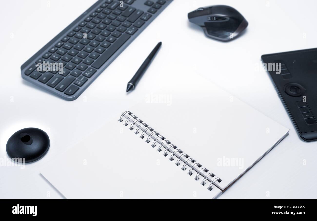 Modern working desk with keyboard, pen, mouse and graphic designer table. Creative person working in advertising from home with copy space Stock Photo