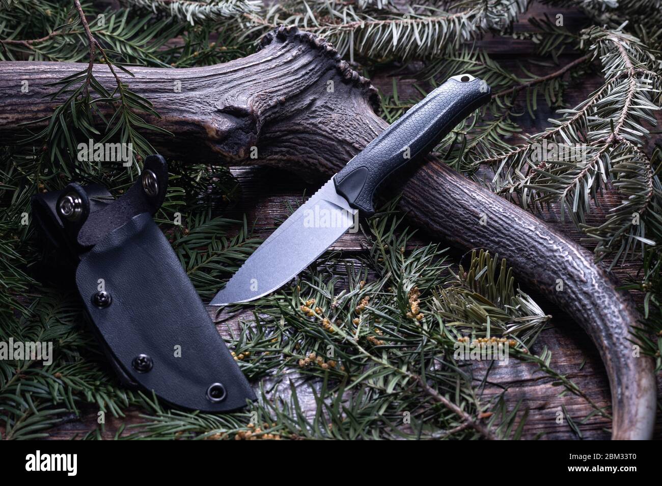 Knife with a fixed blade on a plastic sheath. Deer horn and knife Stock