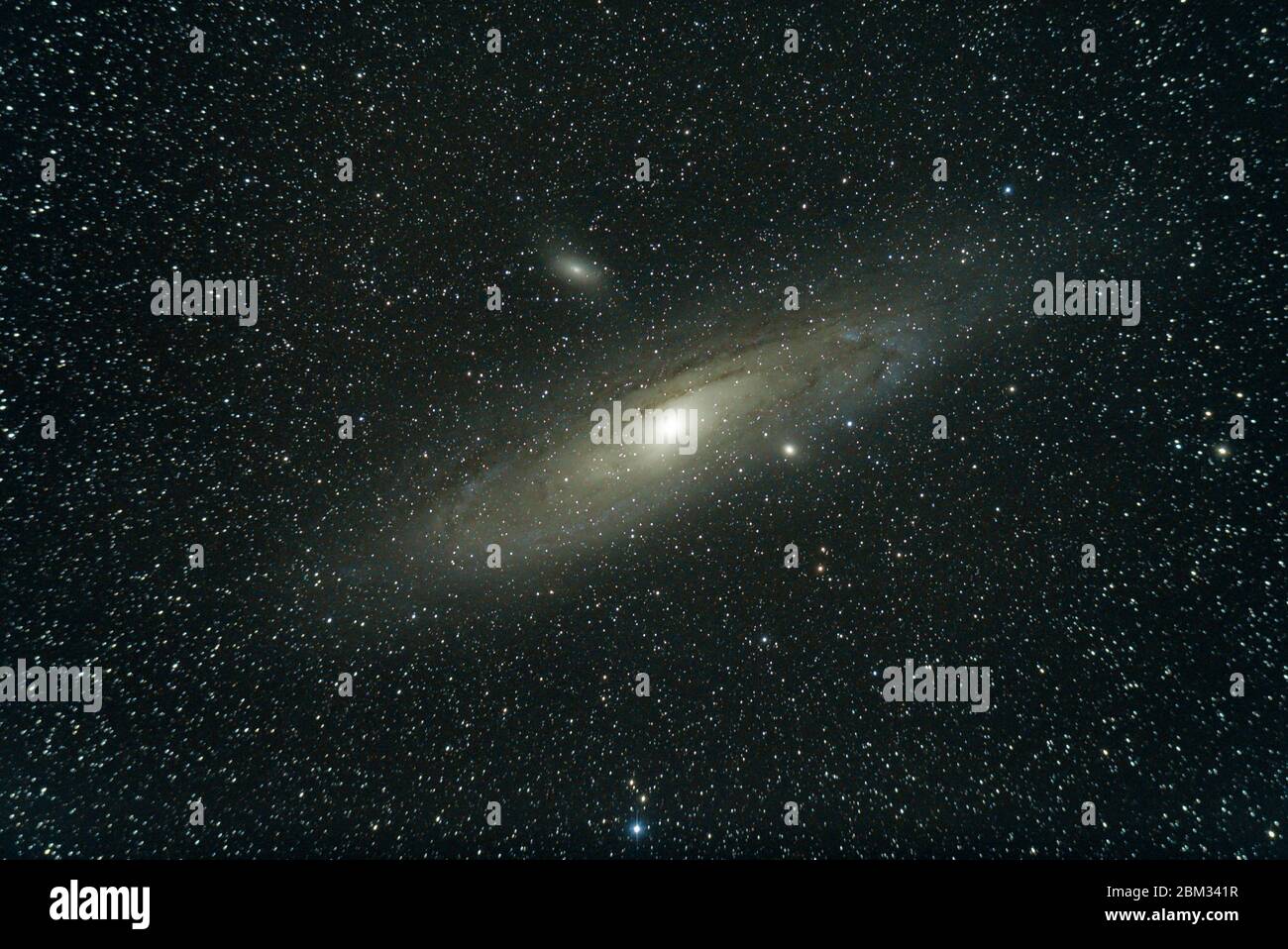The Andromeda Galaxy , also known as Messier 31, and originally the Andromeda Nebula is a barred spiral galaxy, nearest to the Milky Way. Stock Photo