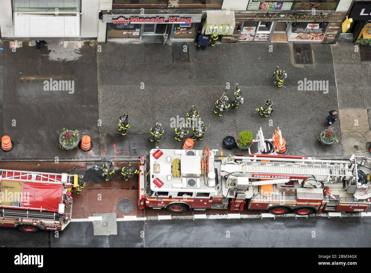 FDNY firemen in full turnout gear respond to an alarm in Midtown Manhattan, NYC, USA Stock Photo