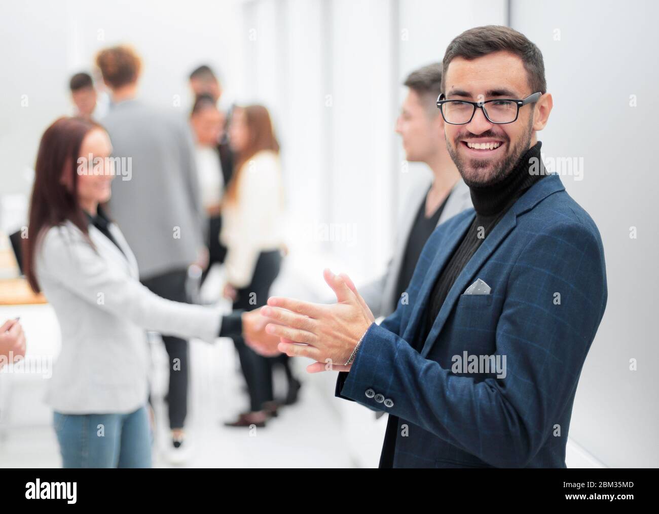 smiling business man standing in the hall of the business center Stock ...