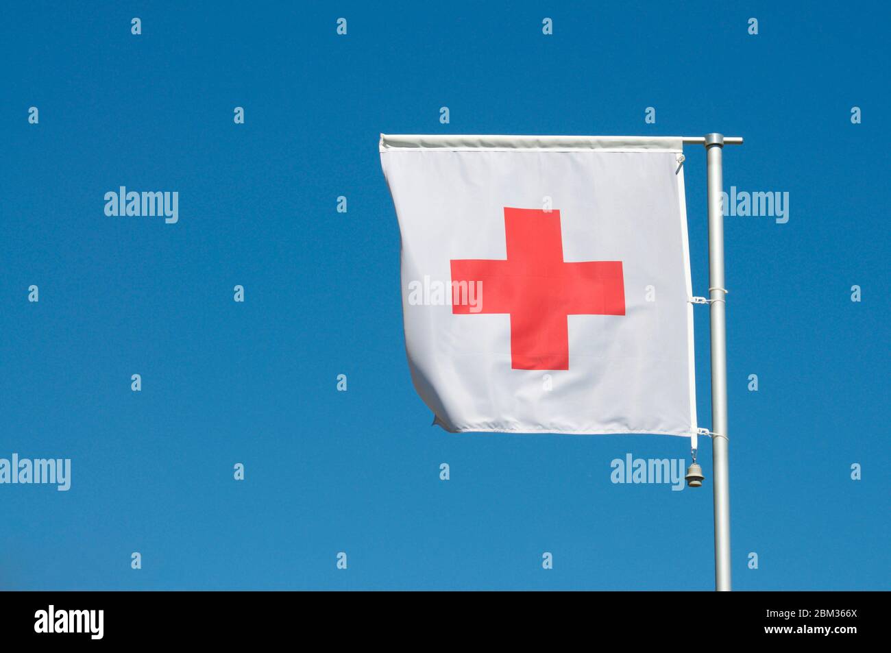 The flag of International Red Cross and Red Crescent Movement against a  blue sky in Manno, Switzerland. The Red Cross is an international  humanitarian Stock Photo - Alamy