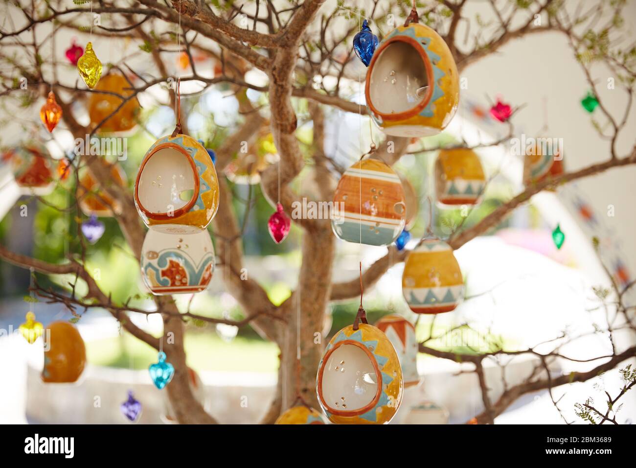 Delicate ceramic ornaments hang from a tree greeting visitors at a luxury resort in Cabo San Lucas, Mexico Stock Photo