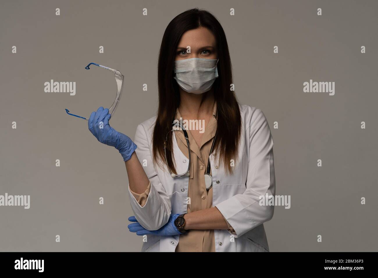 Doctor / Nurse Smiling Behind Surgeon Mask. Closeup Portrait Of Young ...