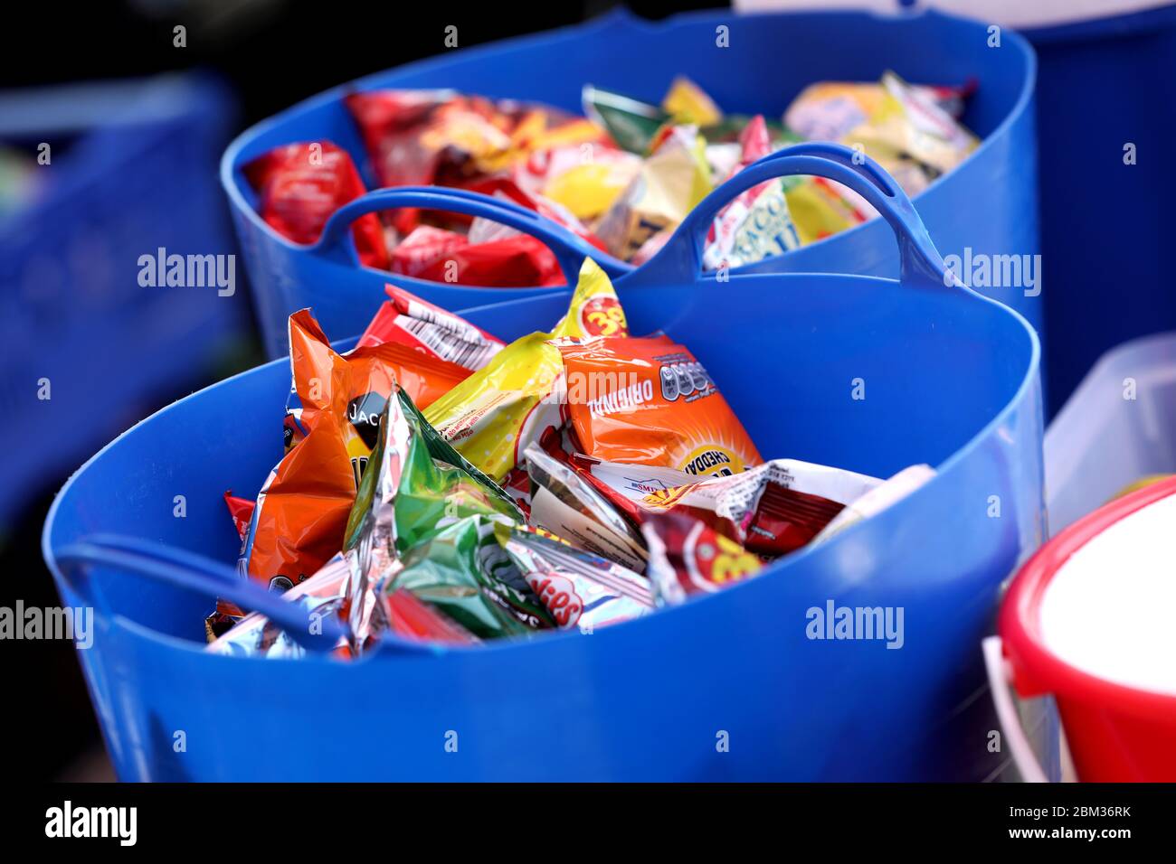 Packets of crisps in a large bowl ready to be picked and eaten in Brighton, East Sussex, UK. Stock Photo