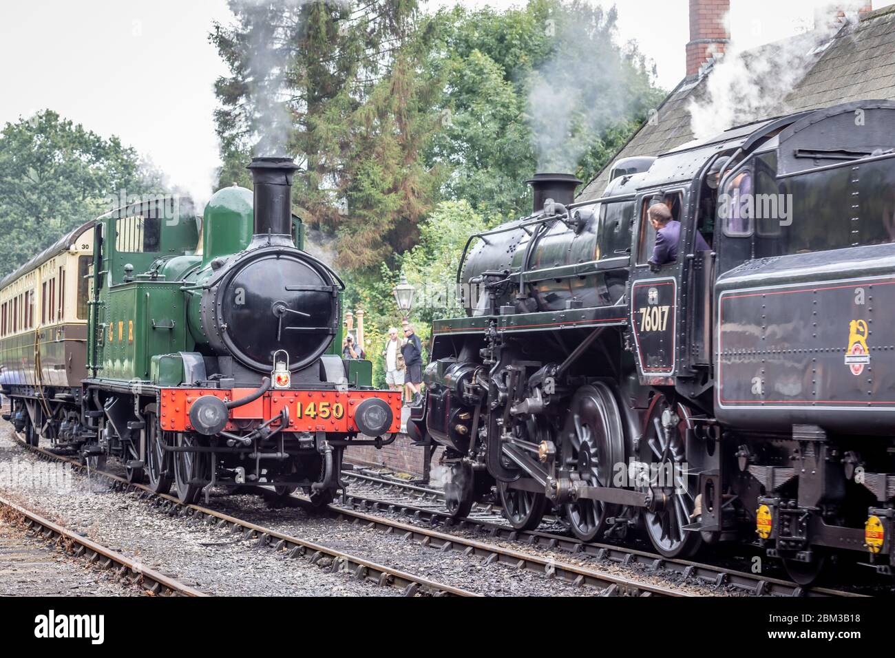 BR 2-6-0 '4MT' No. 76017 passes GWR 0-4-2T '14xx' No. 1450 at Highley on the Severn Valley Railway during their Autumn Steam Gala Stock Photo