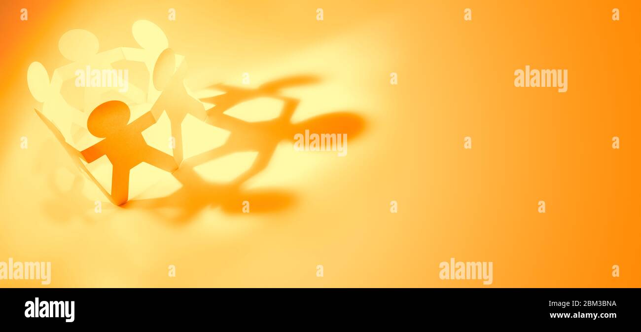 Paper chain team holding hands. Teamwork. Partnership Stock Photo - Alamy