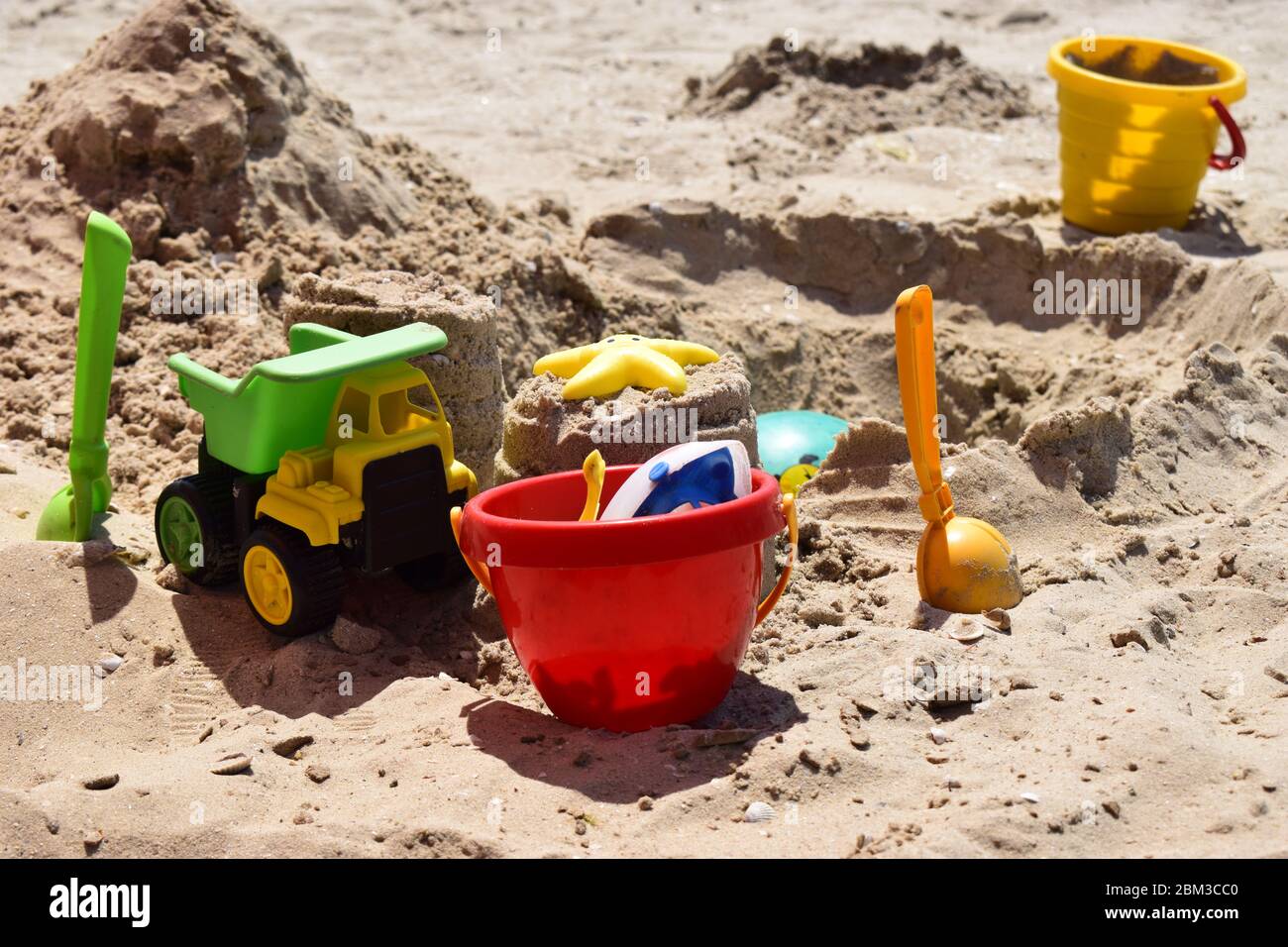 Children's plastic toys green end yellow car, shovel, yellow and red