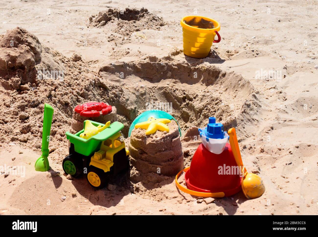 Children's plastic toys green end yellow car, shovel, yellow and red