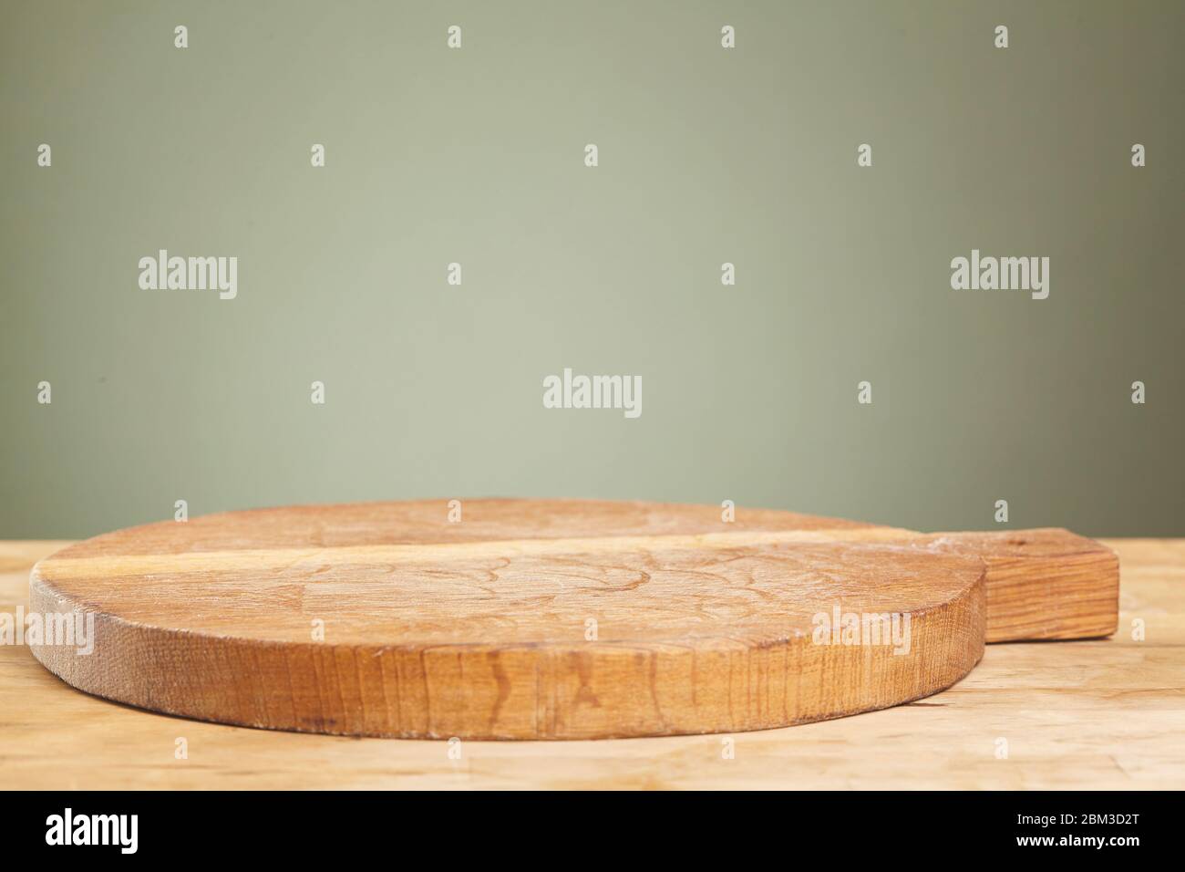 Empty cutting board on a wooden table close up Stock Photo