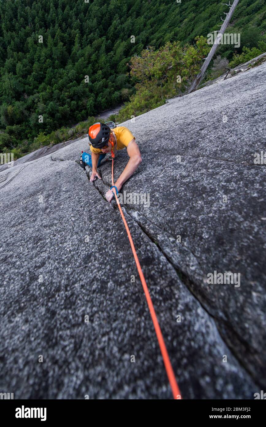 Man rock climbing cracks in granite very exposed in Squamish Chief