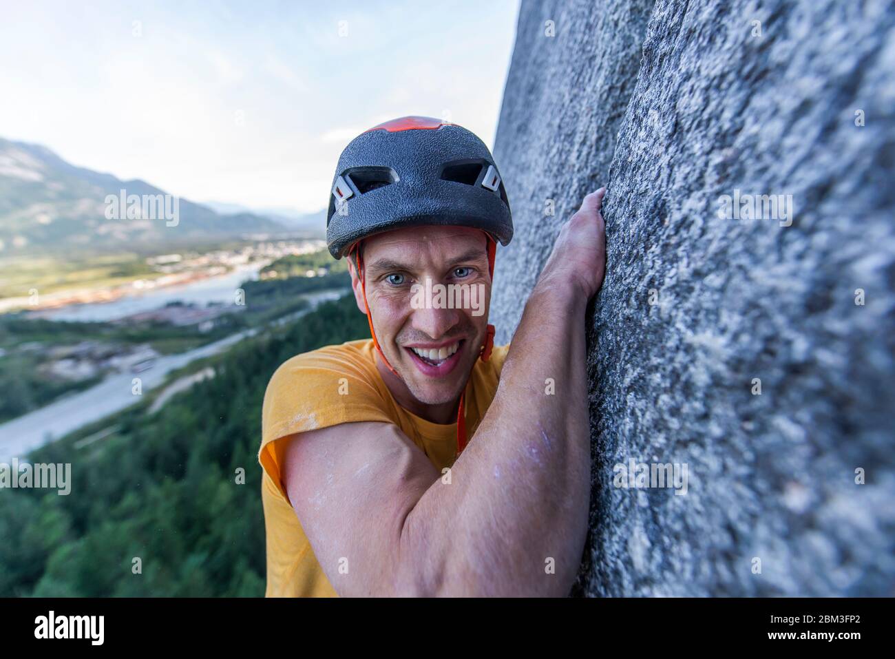 Man struggling lead climbing in off-width climb on granite Squamish Stock Photo
