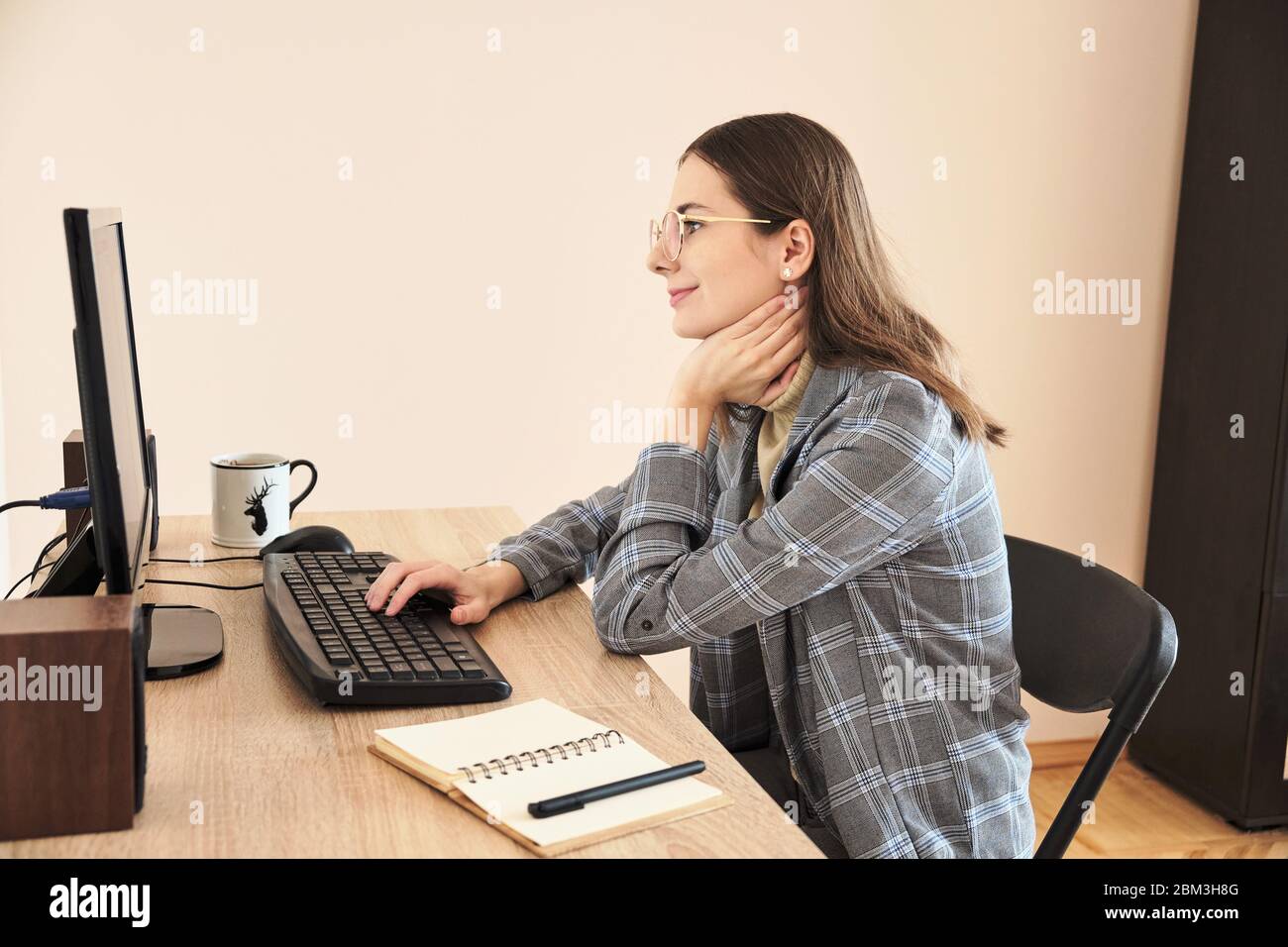 Mature woman using desktop at home Stock Photo