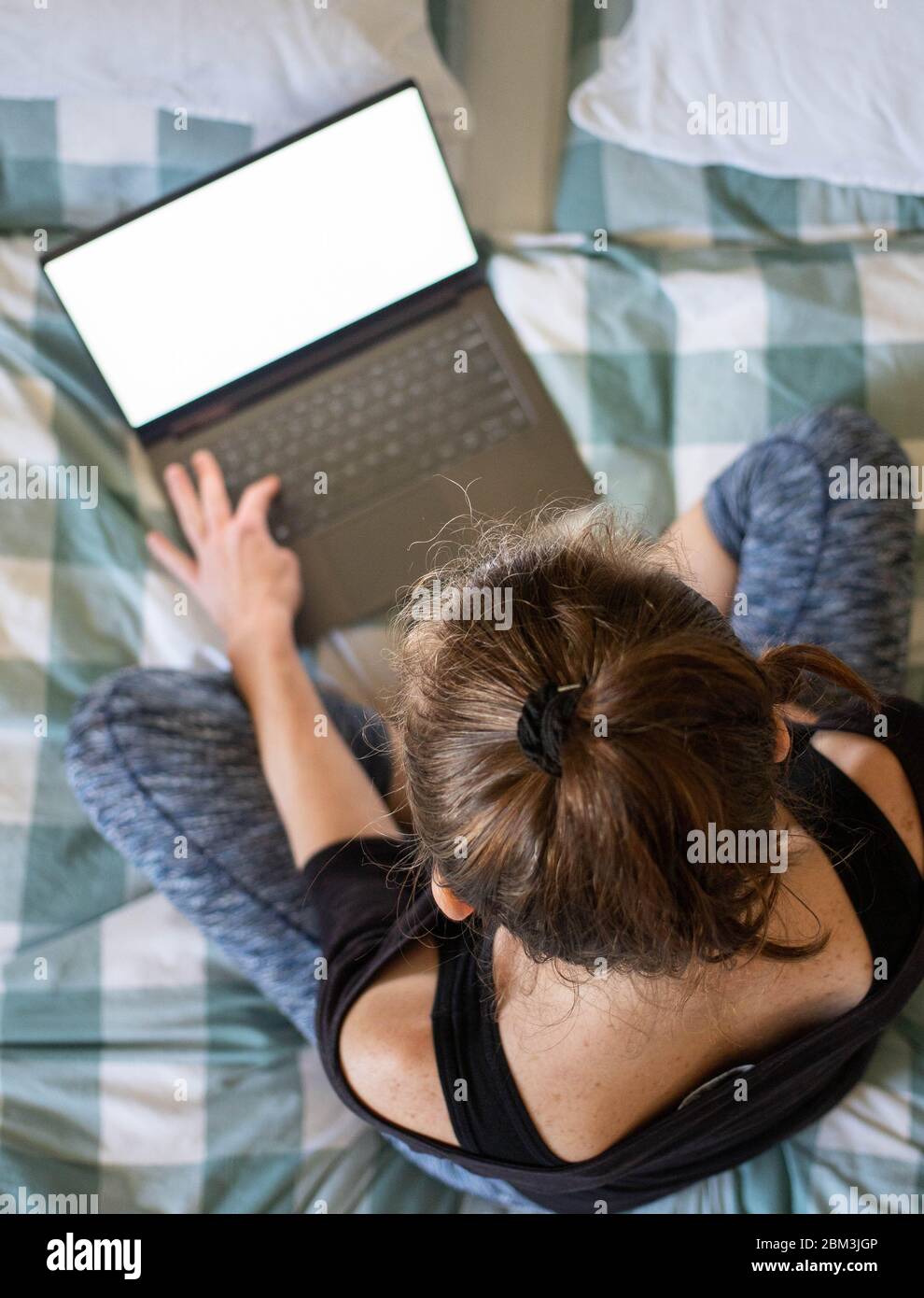 Teenage girl lying bed using tablet hires stock photography and images