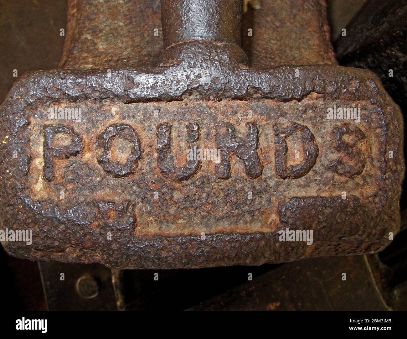 Rusting Iron Machinery inscribed with Pounds, Manchester cotton mill, Lancashire, England, UK Stock Photo