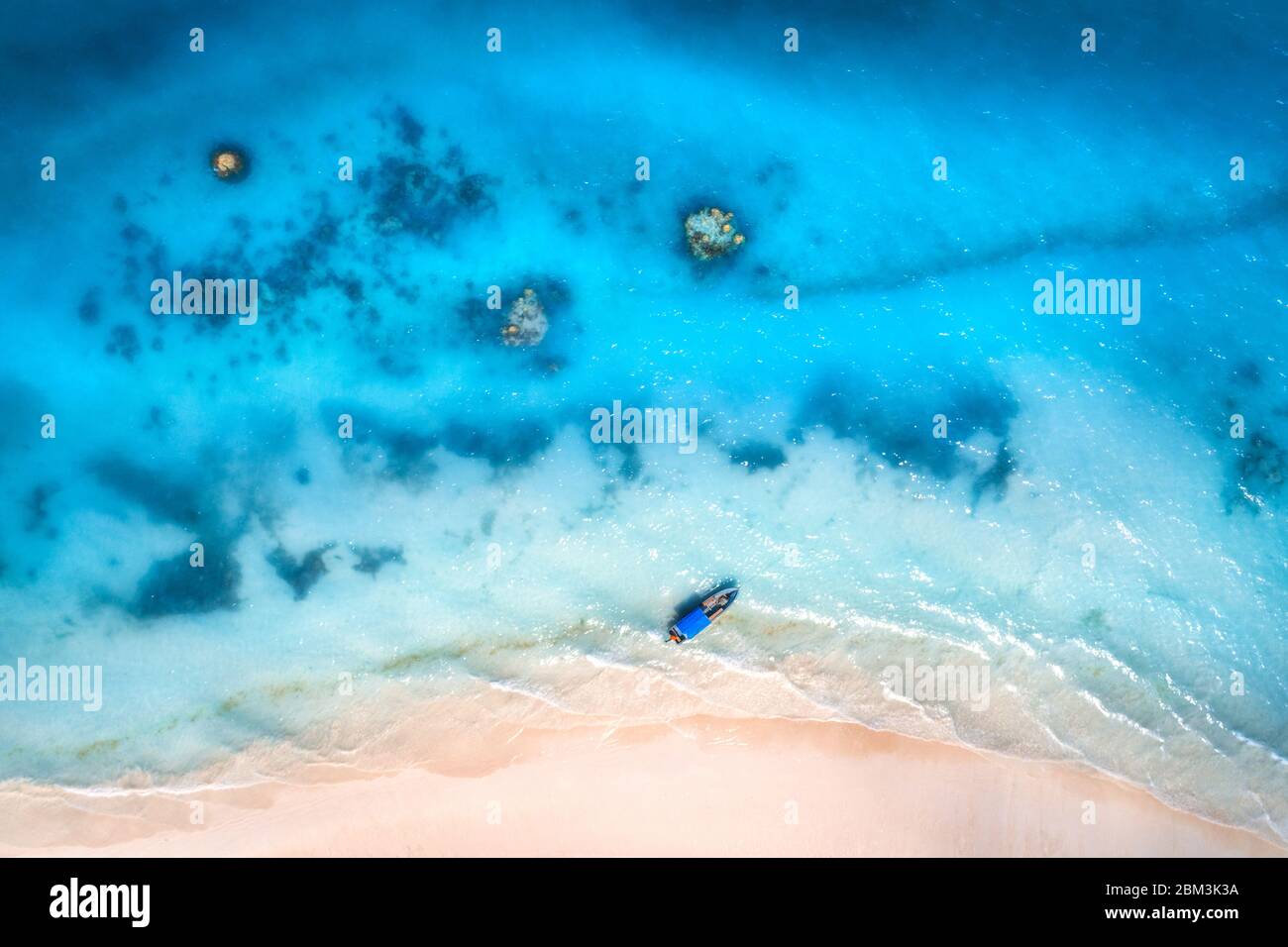 Aerial view of the fishing boat in clear blue water at sunset Stock ...