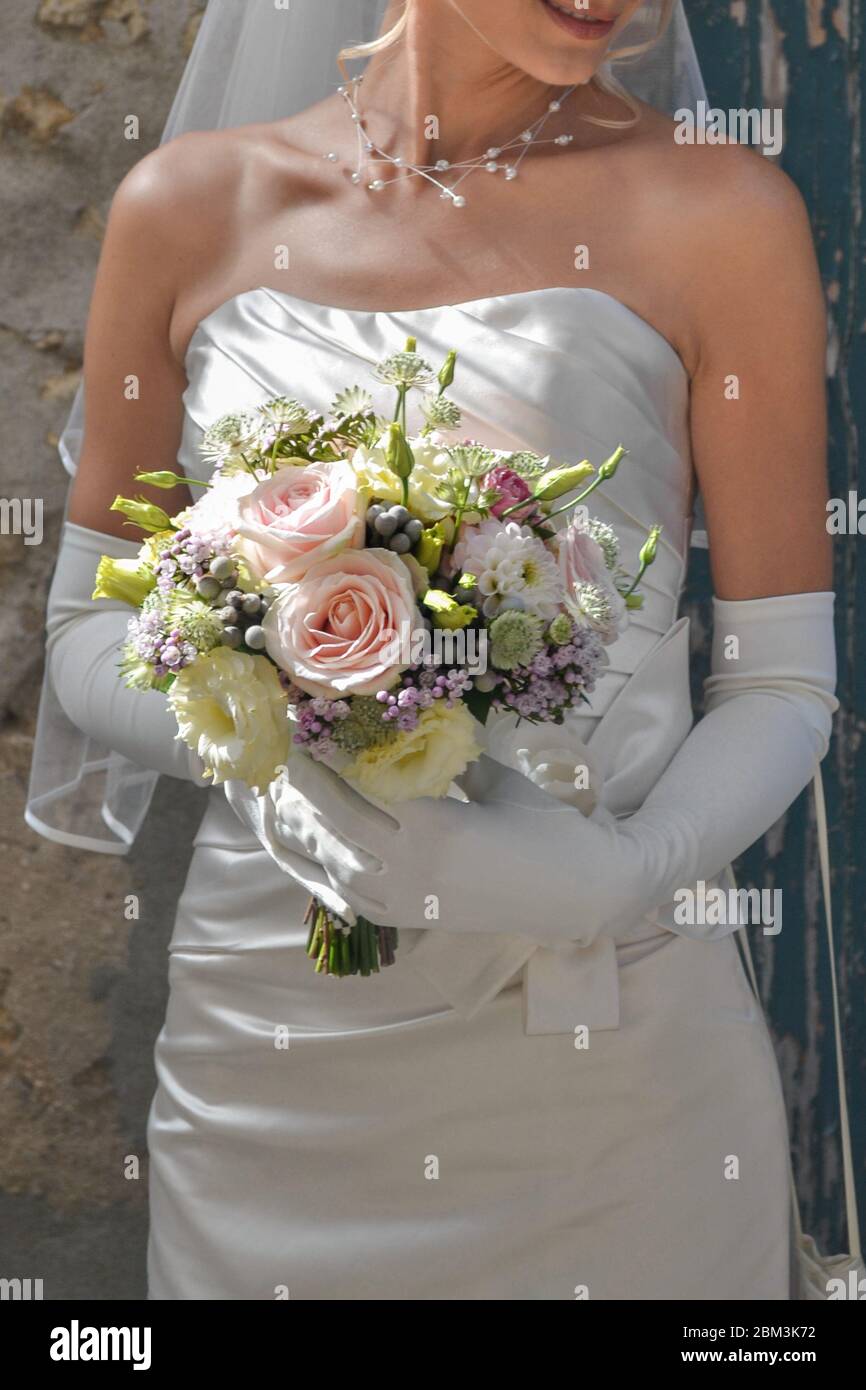 Beautiful wedding bouquet in hands of the bride Stock Photo