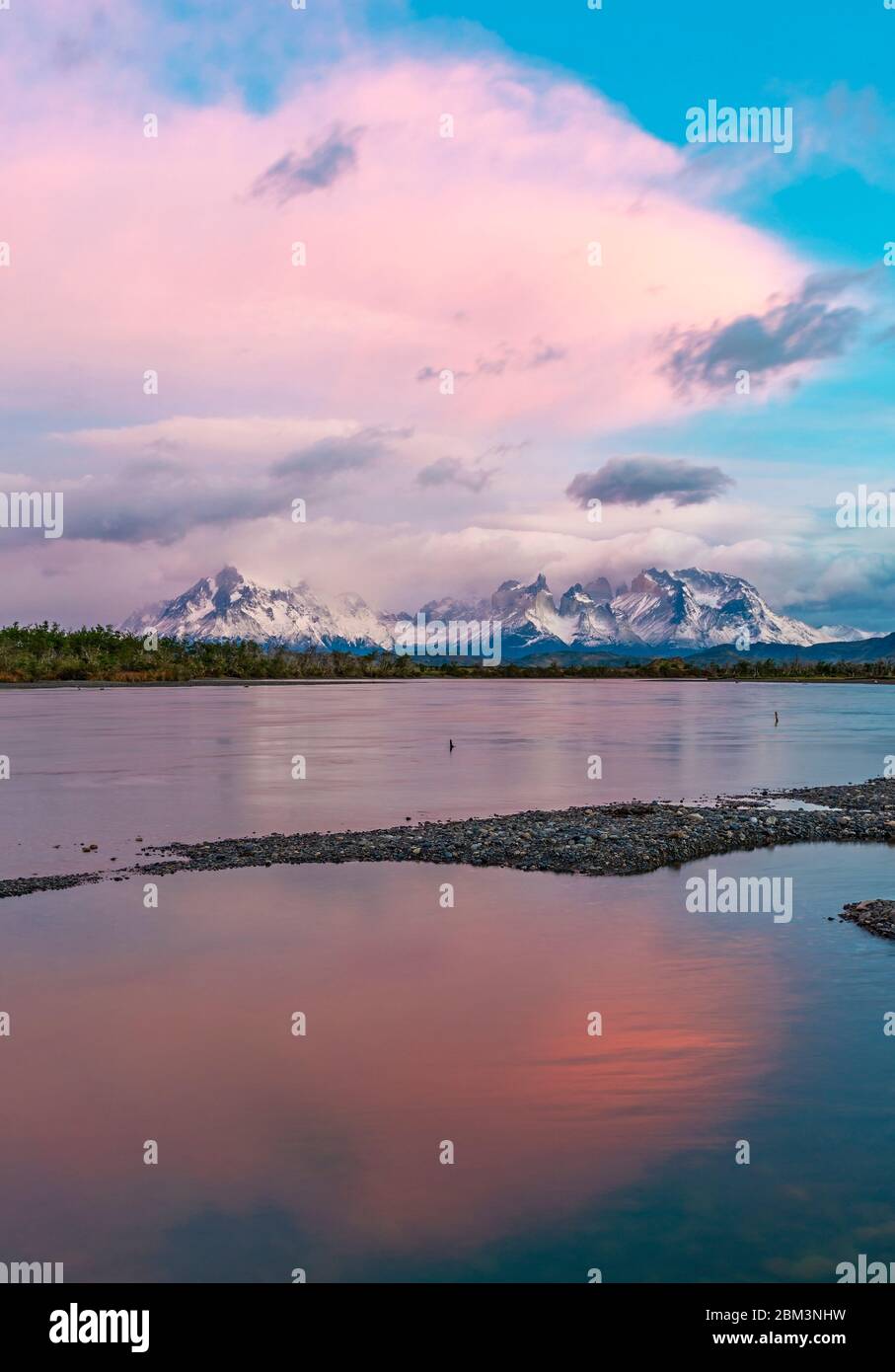 Vertical Sunrise of the Cuernos and Torres del Paine peaks along the Serrano River, Torres del Paine national park, Patagonia, Chile. Stock Photo