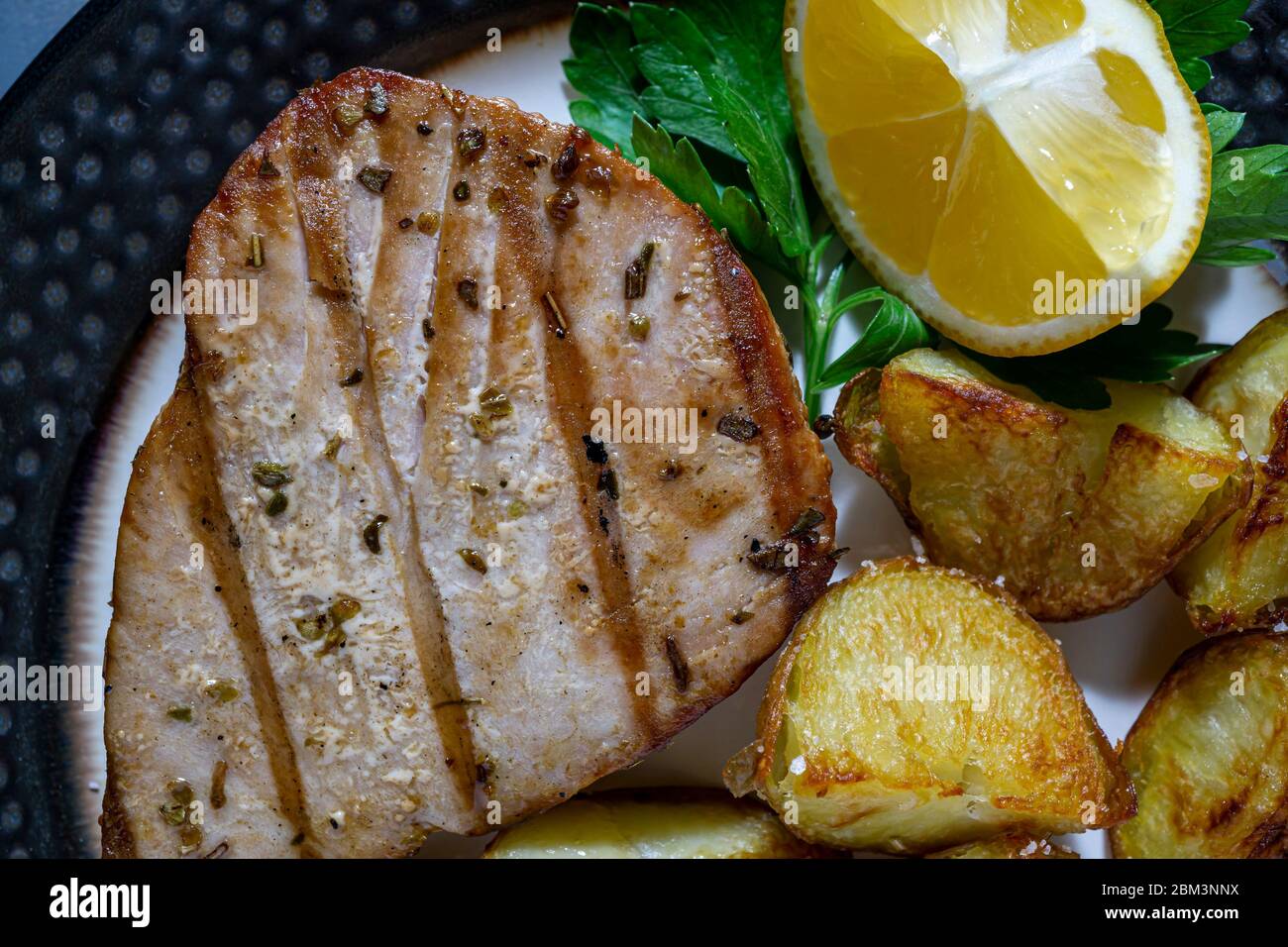 Grilled tuna steak with oven roasted tomatoes Stock Photo Alamy