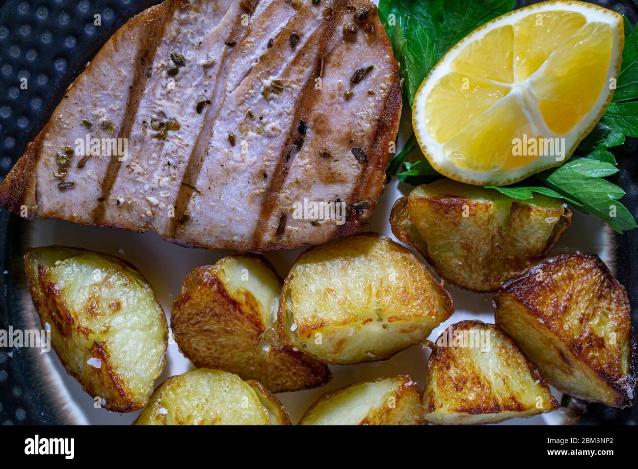 Grilled tuna steak with oven roasted tomatoes Stock Photo Alamy