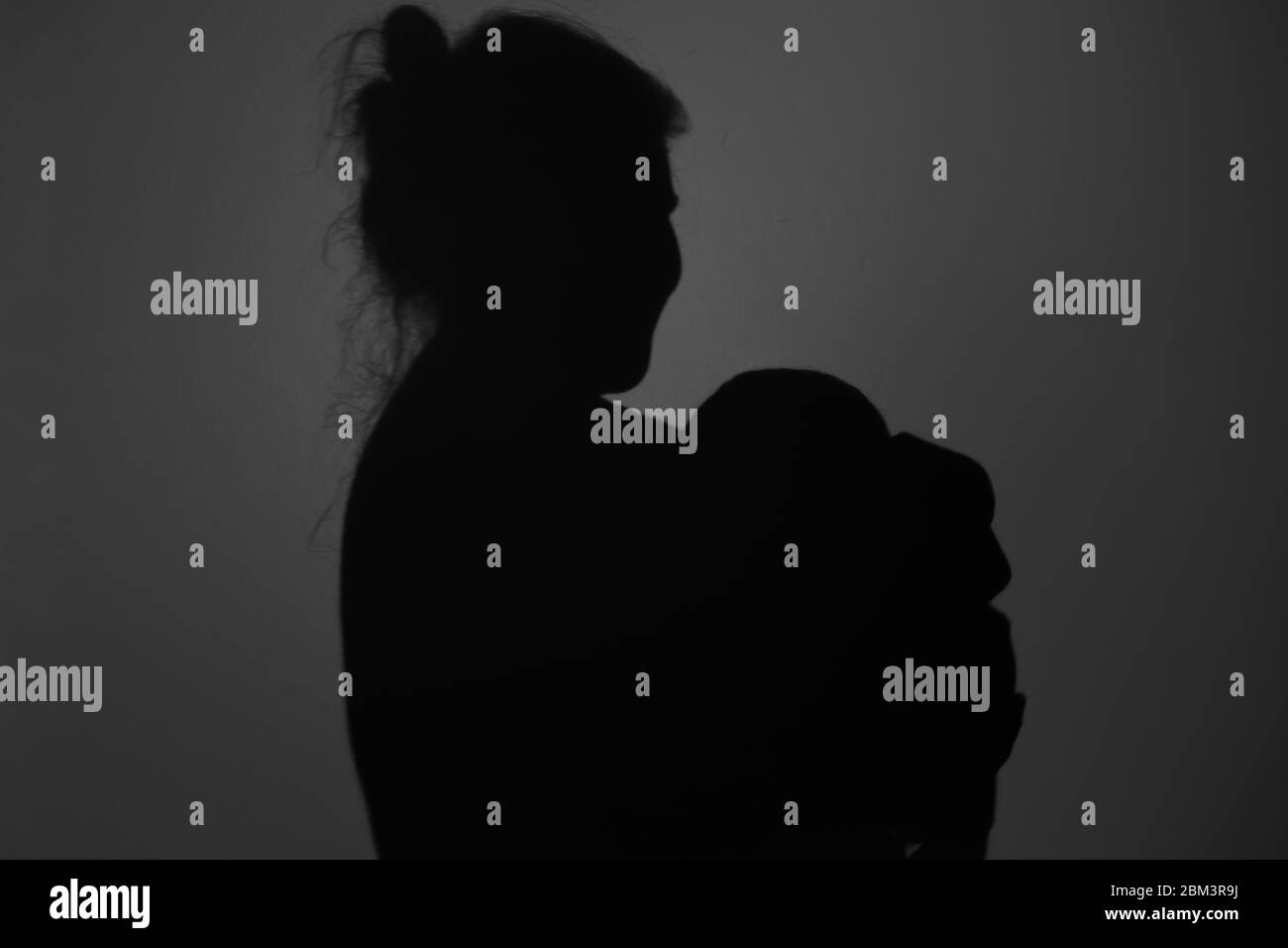 Silhouette Of Happy Mother and Baby. Mom and baby hugging to eachother, Happy Mother's Day concept Stock Photo