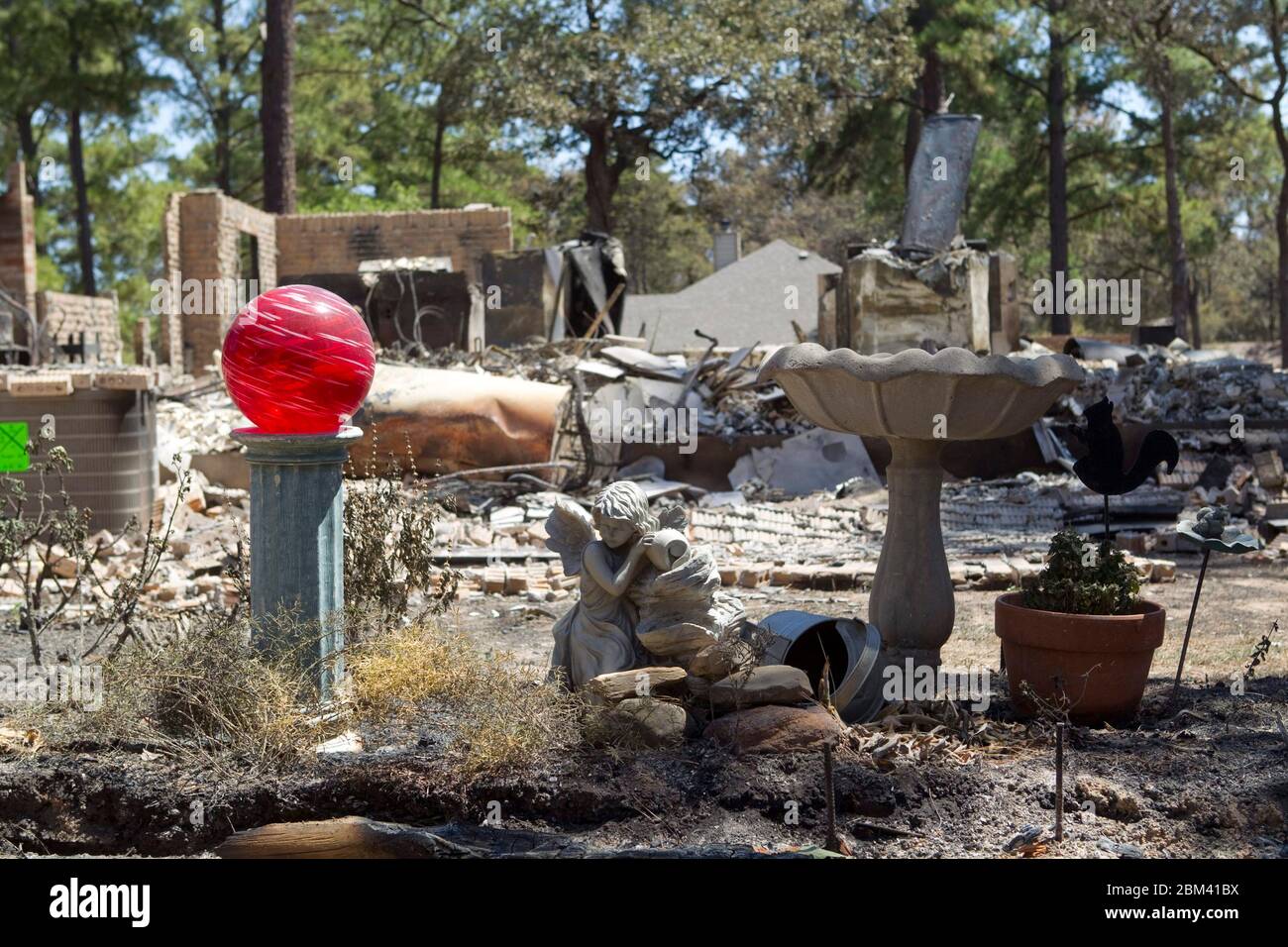 Bastrop County Texas USA, September 9, 2011: The aftermath of wildfire through the piney woods in Bastrop County is shown in this destroyed home, where stone, brick and concrete pieces remained intact while wooden structures burned. The fires destroyed more than 1,400 houses and scorched more than 38,000 acres while it was out of control for five days. ©Bob Daemmrich Stock Photo