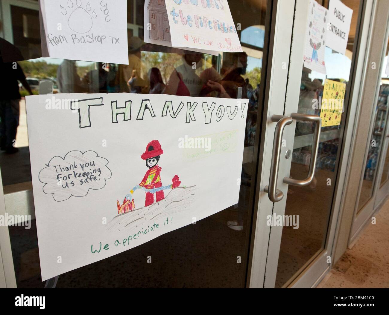 Bastrop, Texas USA, September 9, 2011: Thank you notes written by children to firefighters are posted on doors of the Bastrop Convention Center, where evacuees and others affected by wildfires in the area have congregated. The forest fires, which races through rural and heavily-wooded residential areas, burned more than 1,400 homes and buildings over 38,000 acres.  ©Marjorie Kamys Cotera/Daemmrich Photography Stock Photo