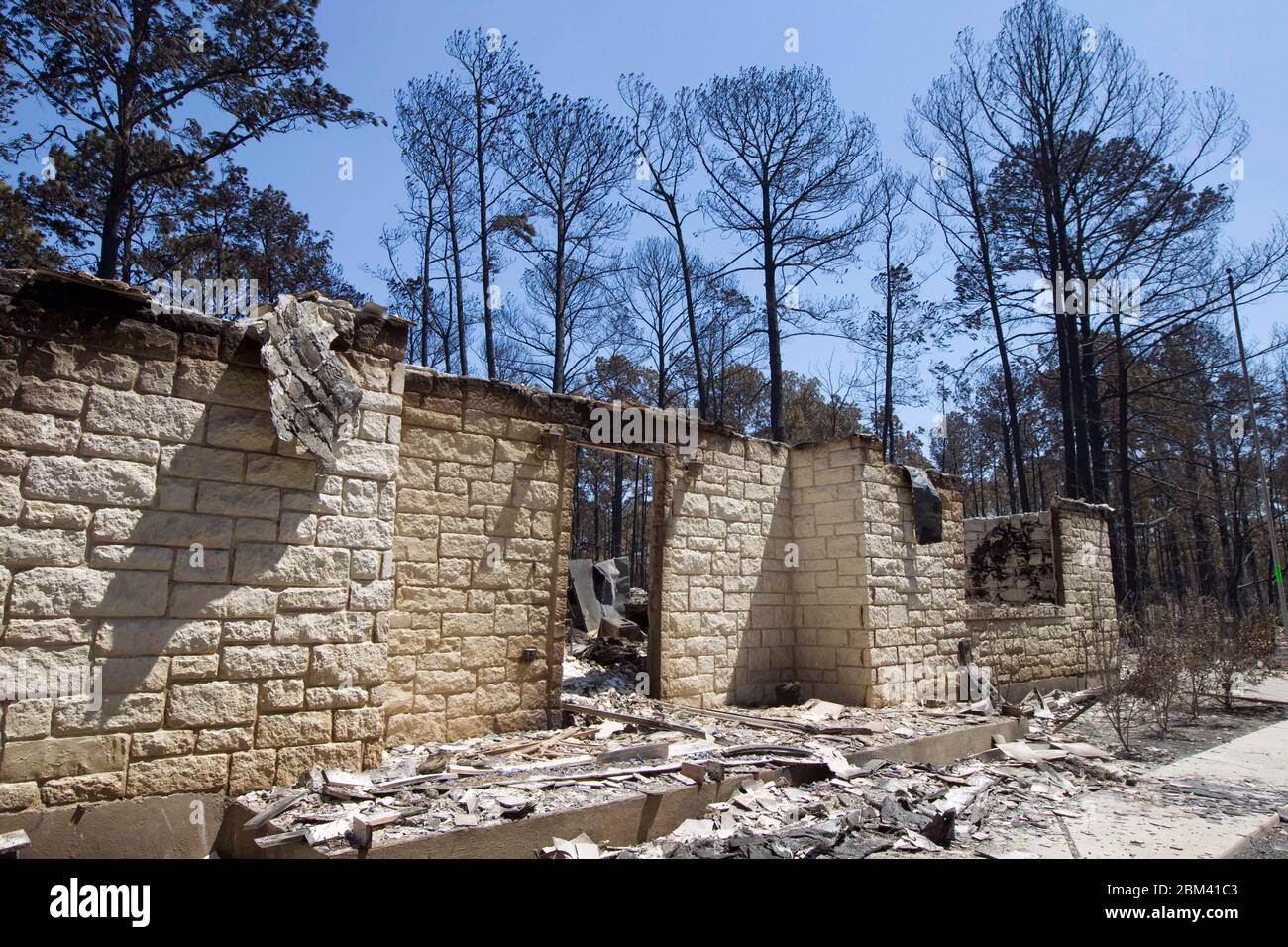 Bastrop County Texas USA, September 9, 2011: The aftermath of wildfire through the piney woods in Bastrop County 30 miles east of Austin is shown in this destroyed homestead. The fires destroyed more than 1,400 houses and scorched more than 38,000 acres while it was out of control for five days. ©Bob Daemmrich Stock Photo