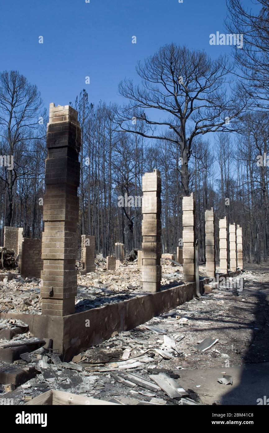Bastrop County Texas USA, September 9, 2011: Brick columns are all that remain of a building in the aftermath of wildfire through the piney woods in Bastrop County 30 miles east of Austin. The fires destroyed more than 1,400 houses and scorched more than 38,000 acres while it was out of control for five days. ©Bob Daemmrich Stock Photo