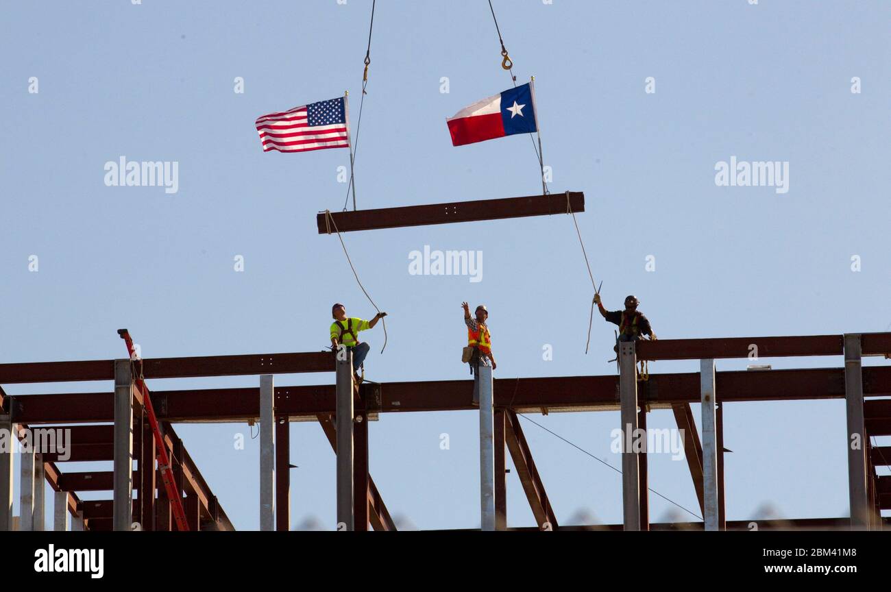 Dallas, Texas - October 3, 2011. Workers place the last beam to finish framing during a construction tour of the George W. Bush Presidential Center on the campus of Southern Methodist University. When the center is completed in the spring of 2013, it will comprise a 226,000- square-foot building with offices, presidential archives, research, restaurants and classroom space over the 25-acre site. ©Bob Daemmrich Stock Photo