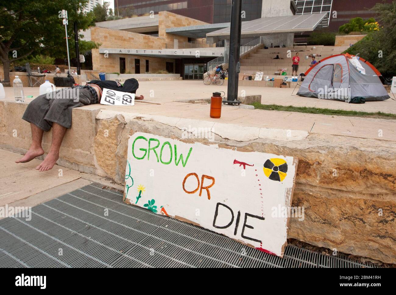 Austin, Texas USA, October 7, 2011: A tired protester takes a break  in the early morning hours of an Occupy Austin demonstration at City Hall in downtown. Occupy Austin is an offshoot of Occupy Wall Street, an ongoing protest that denounces the role that large companies play in the current financial crisis. Protesters have been camping out on the city hall plaza for several days. ©Marjorie Kamys Cotera/Daemmrich Photography Stock Photo