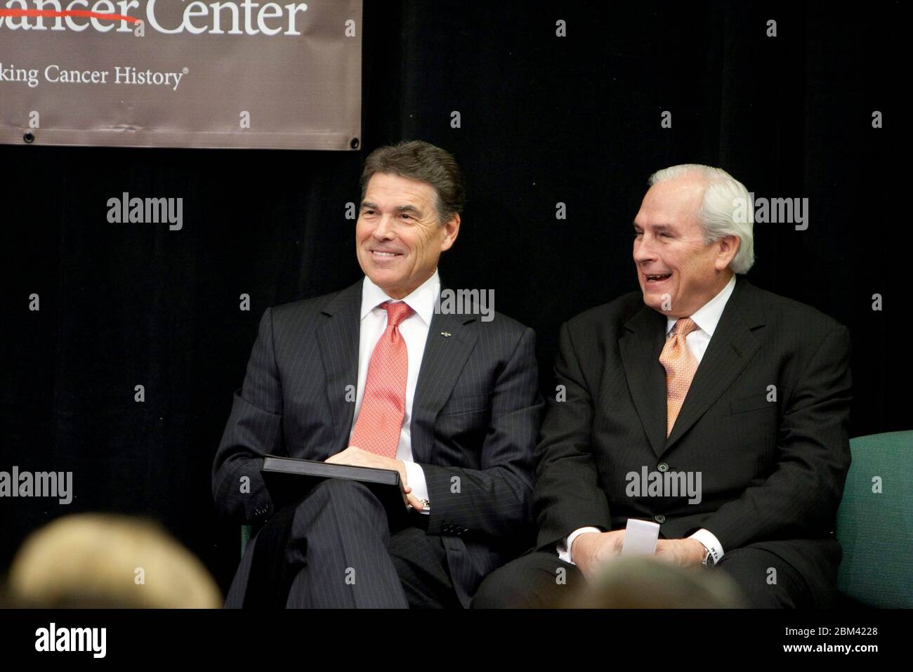Houston, Texas USA, November 28, 2011: Texas Gov. Rick Perry sits next to University of Texas System Board of Regents Chairman Eugene 'Gene' Powell at announcement of new Institute for Applied Cancer Science at The University of Texas MD Anderson Cancer Center. ©Marjorie Kamys Cotera/Daemmrich Photography Stock Photo