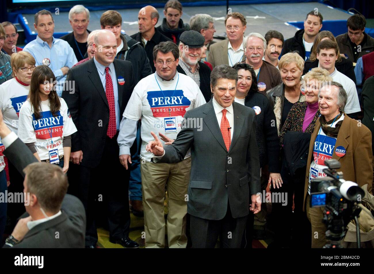 West Des Moines, Iowa USA, January 3, 2012: Supporters stand behind Rick Perry, Texas governor and candidate for the Republican presidential nomination, as he tells a TV news reporter that he is going to stay in the campaign despite his fifth-place finish in the Iowa caucuses. © Bob Daemmrich Stock Photo