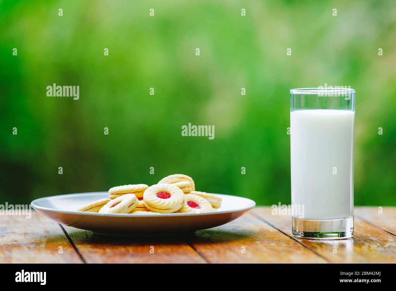 A glass of milk on green background. Glass Stock Photo