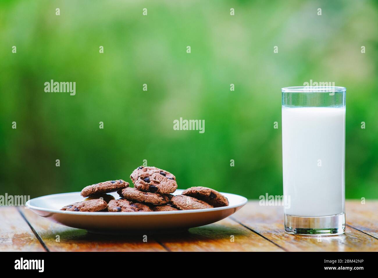 A glass of milk on green background. Glass Stock Photo