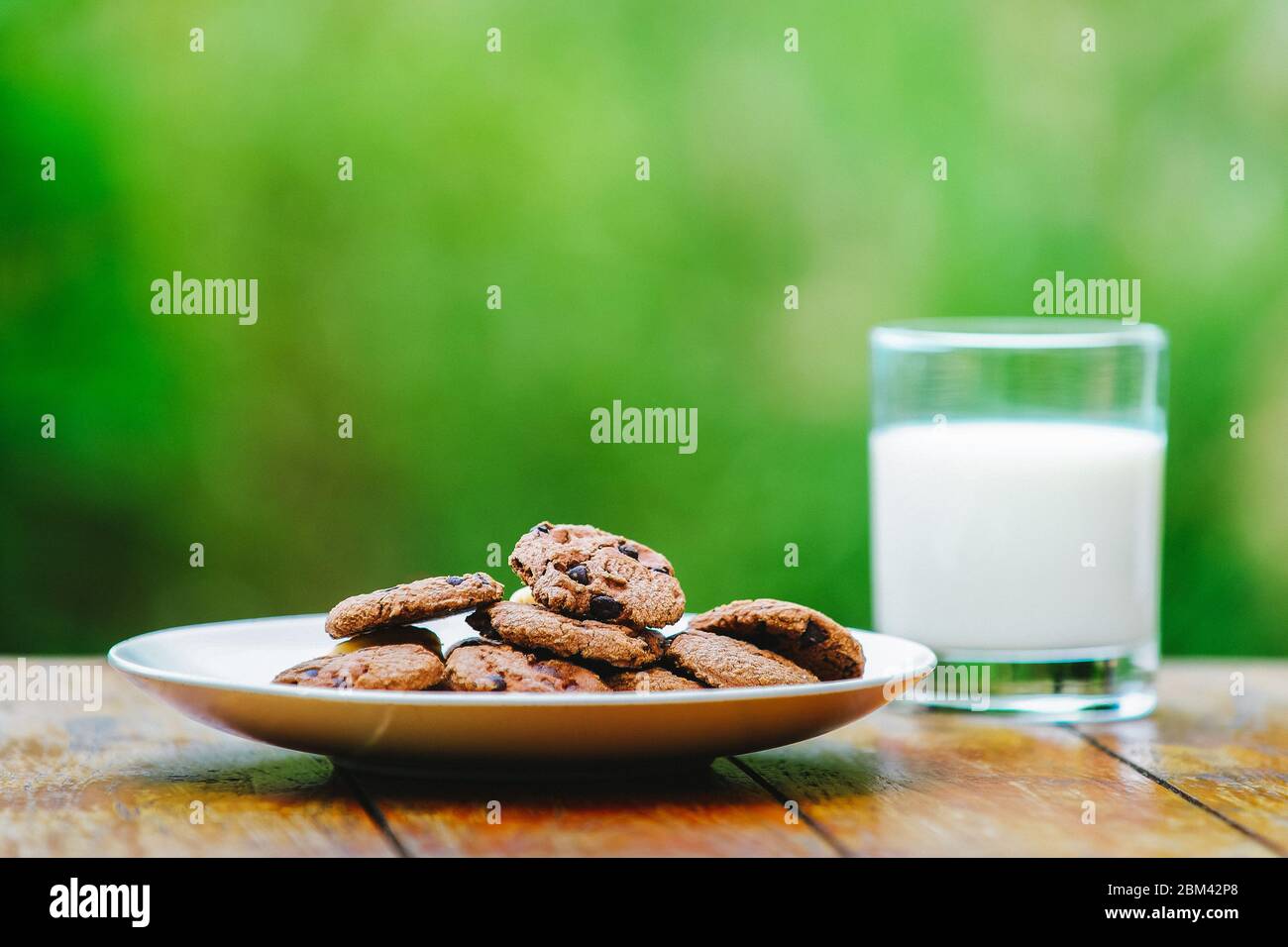 A glass of milk on green background. Glass Stock Photo