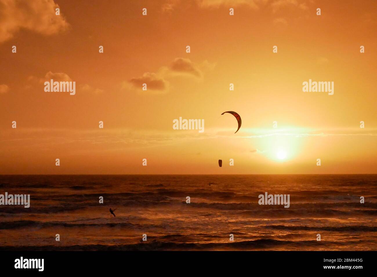 Para surfing at sunset Stock Photo