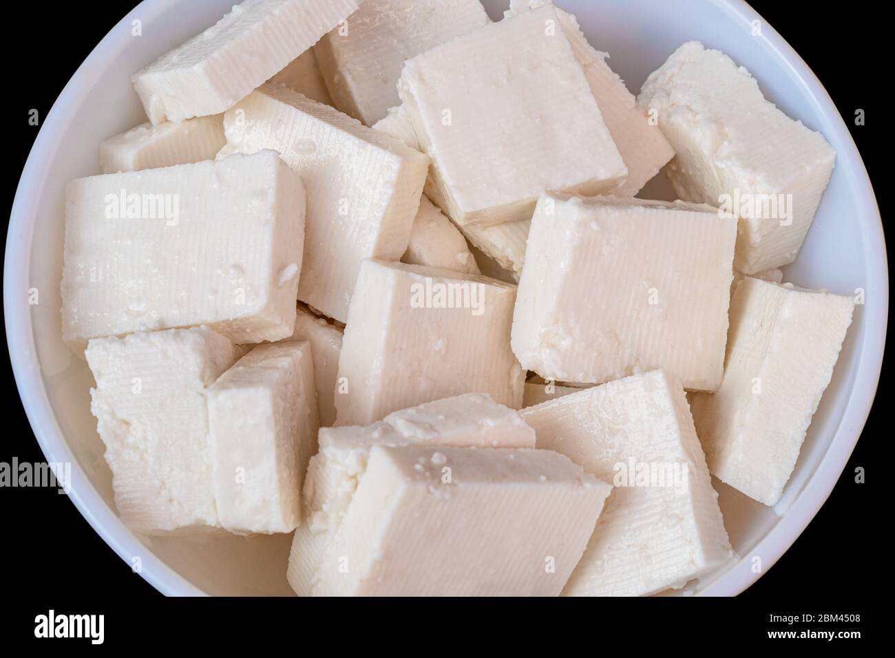 Paneer cottage cheese close up, slice pieces of homemade fresh white raw panner cheese. Stock Photo