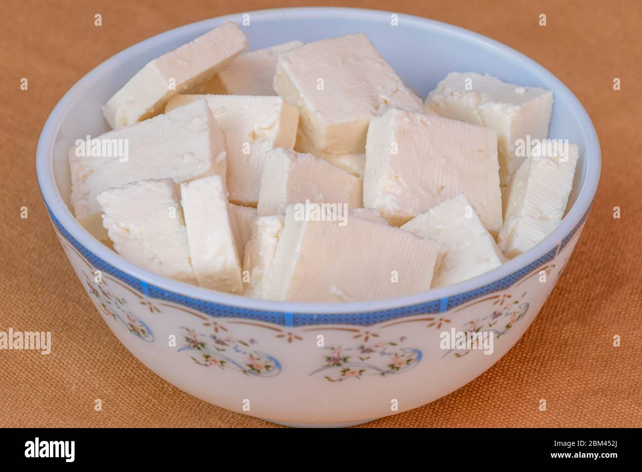 Paneer cottage cheese close up, slice pieces of homemade fresh white raw panner cheese. Stock Photo