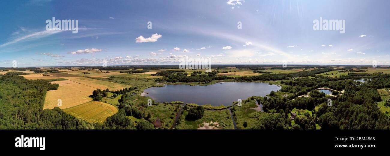 Summer end farmland panorama with lake, aerial view Stock Photo
