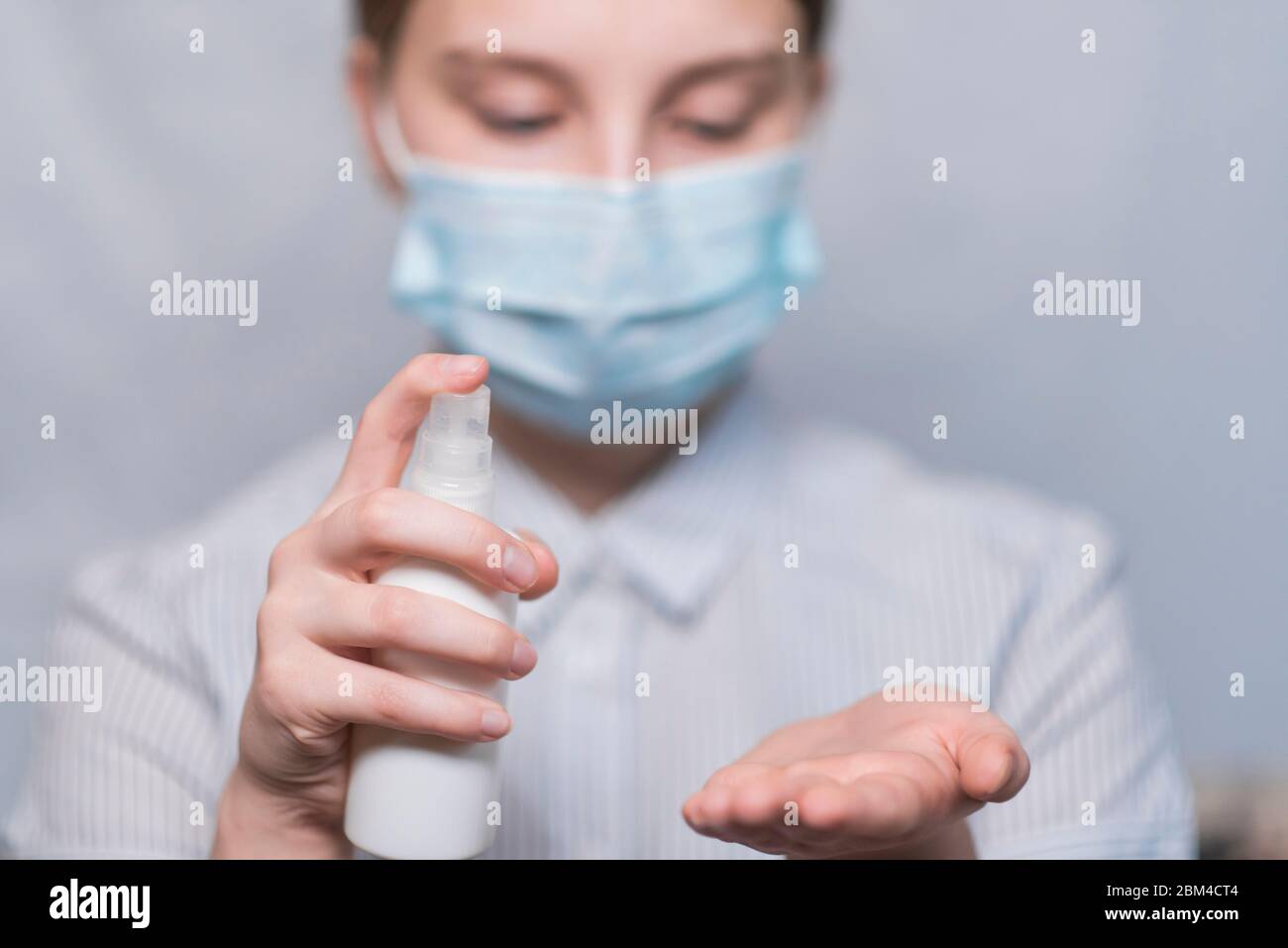 Closeup, teenage girl, children's hands apply antiseptics palm of his