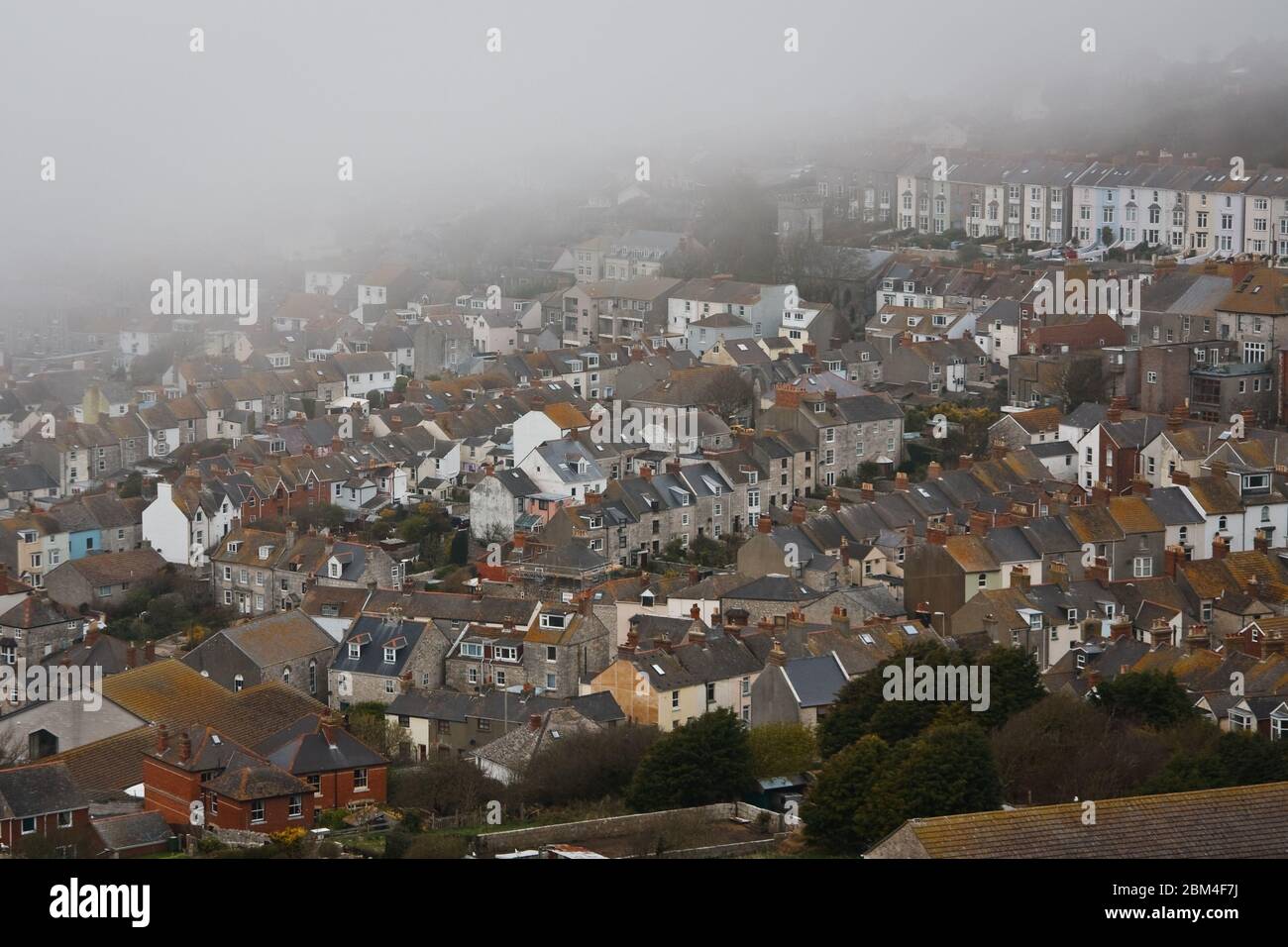 Portland houses in fog, Dorset, UK Stock Photo Alamy