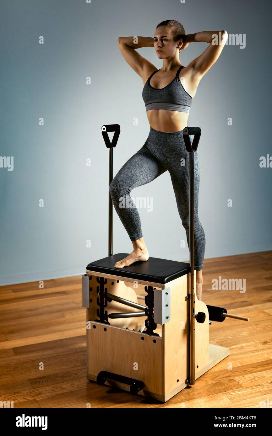Pilates reformer chair woman fitness yoga gym exercise. Correction