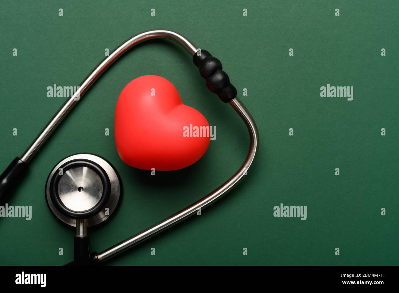 top view heart and stethoscope on a green background with copy space ...