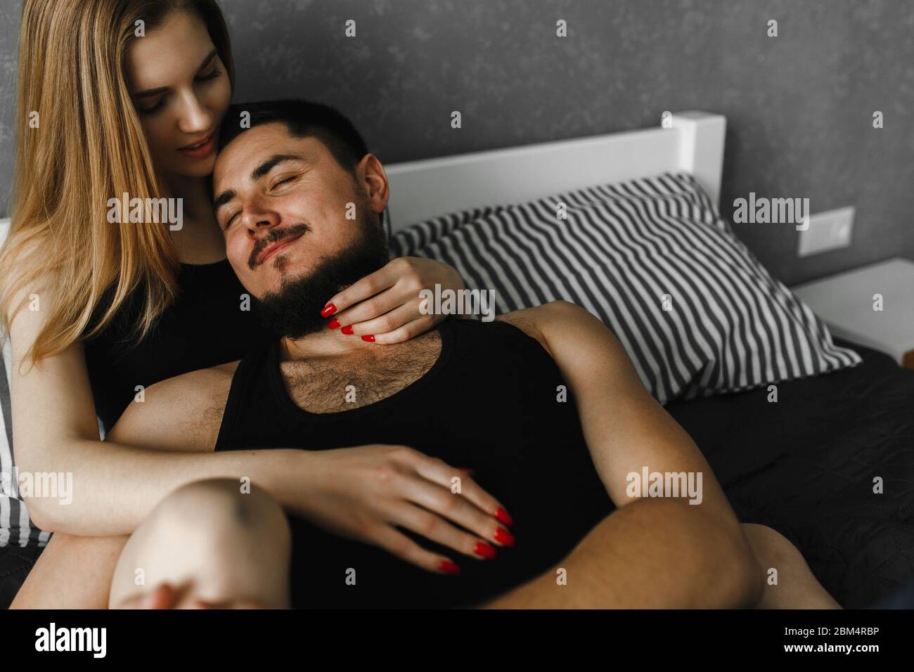 Man feeling happiness while her woman embracing him. Stay home Stock Photo