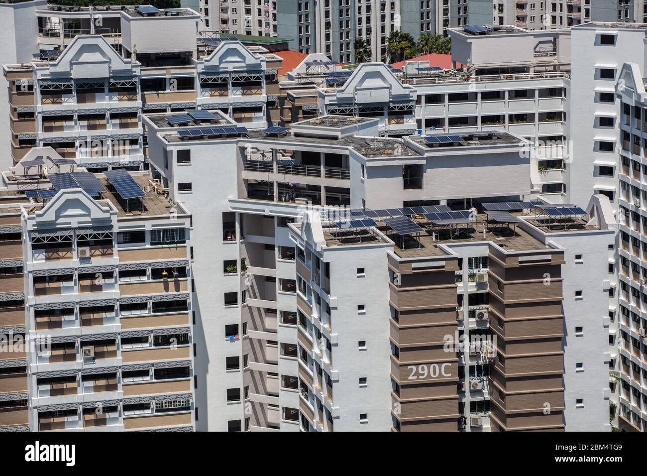 Aerial view of solar panels installed on housing estates rooftops to convert natural sunlight to solar energy to electricity usage, Singapore. Stock Photo