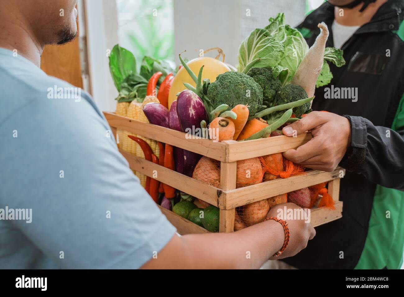 grocery online shopping. asian man delivering food to customer Stock