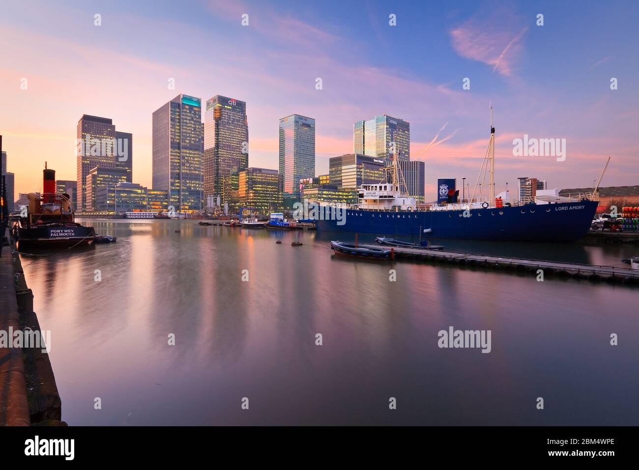 Evening In The South Dock And Canary Wharf At The Background Stock evening-in-the-south-dock-and-canary-wharf-at-the-background-stock