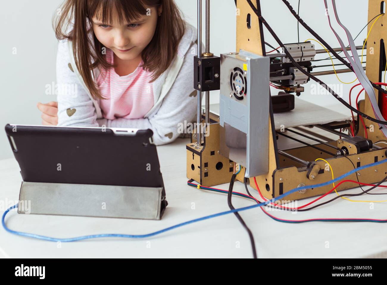 Child student makes the item on the 3D printer. School, technologies ...
