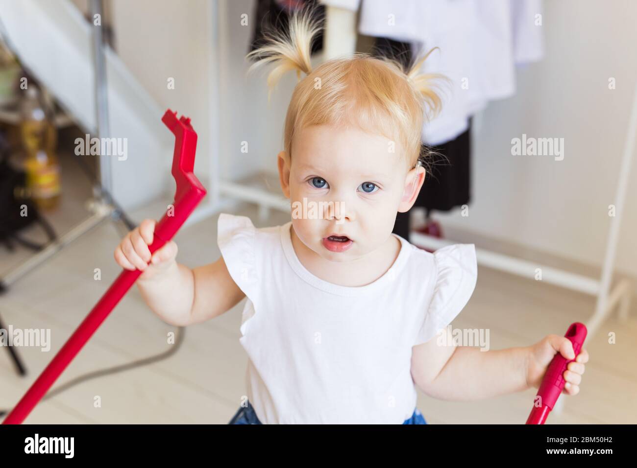 Baby girl wearing a hearing aid. Disabled child, disability and